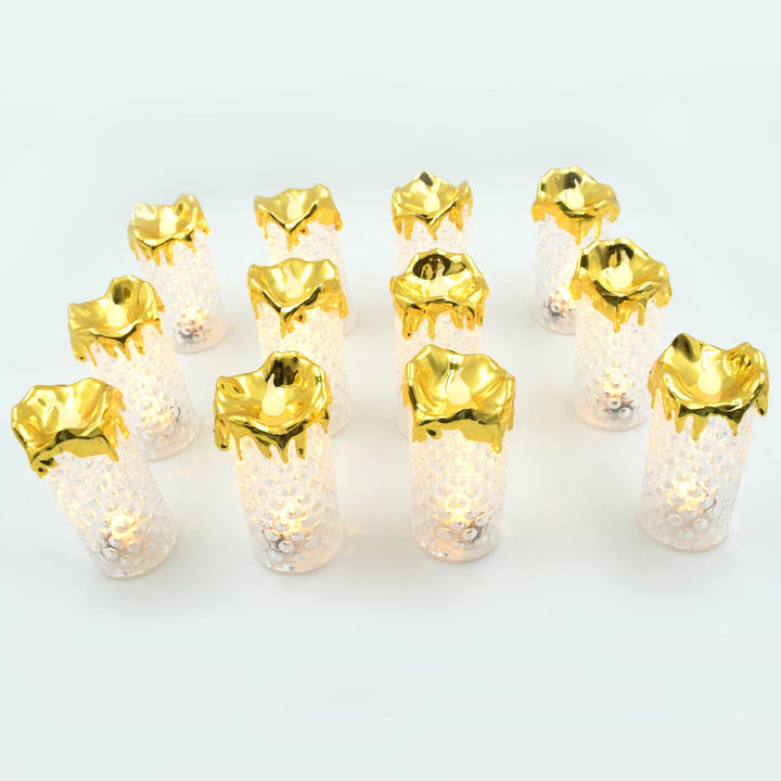 Gold flameless candles arranged on a table, adding a touch of elegance to home decor and weddings.